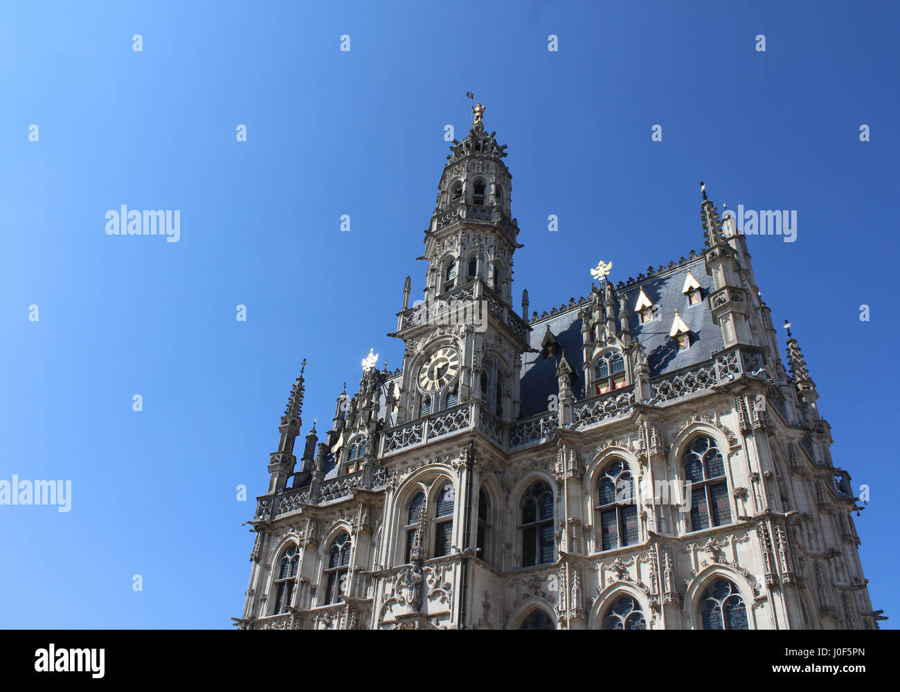 The beautiful 14th century, late gothic style Oudenaarde Town Hall,  in East Flanders in Belgium. Against a background of blue sky with copy space. Stock Photo