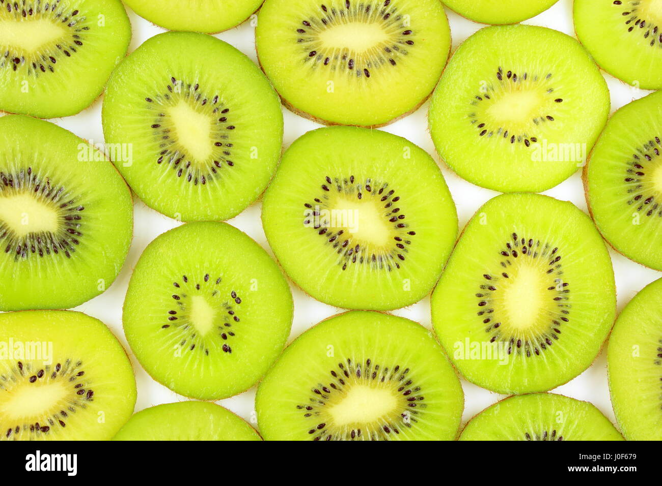 slices of fresh green kiwi fruits as a food background texture Stock Photo
