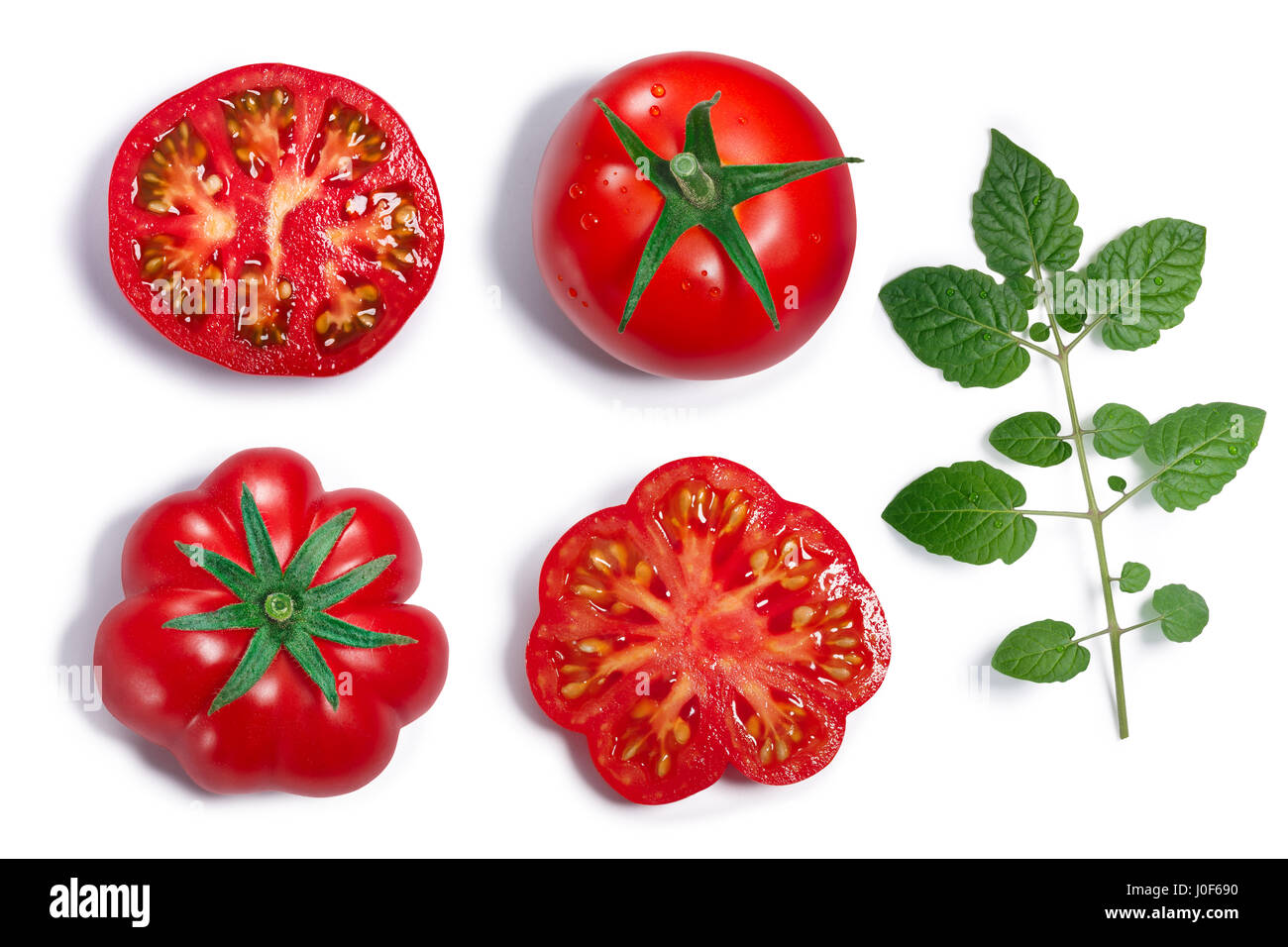 Fresh ripe round and ribbed tomatoes with sepal, whole and half, leaf. Top view, clipping paths, shadows separated Stock Photo