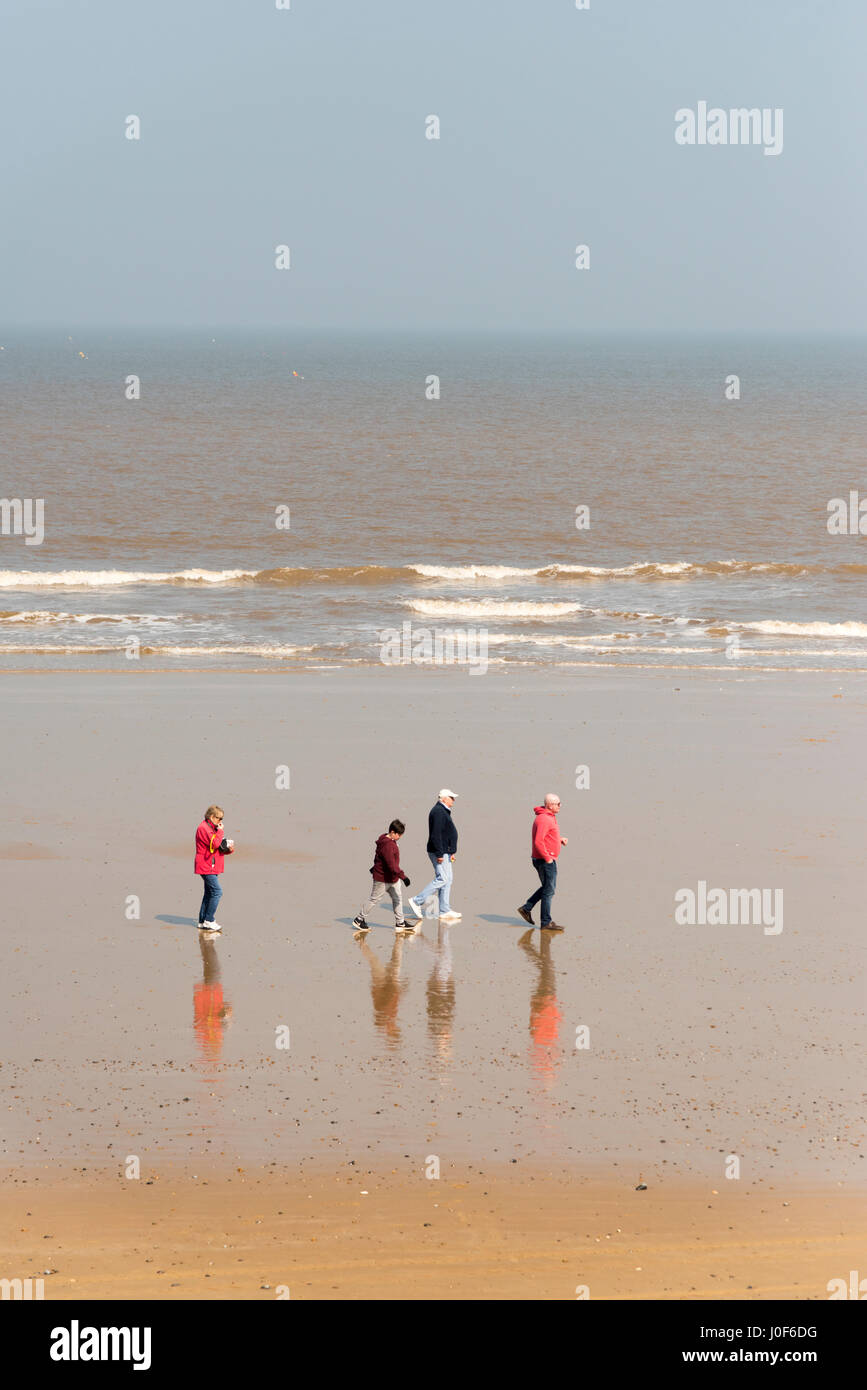 Family of four walking on beach hi-res stock photography and images - Alamy