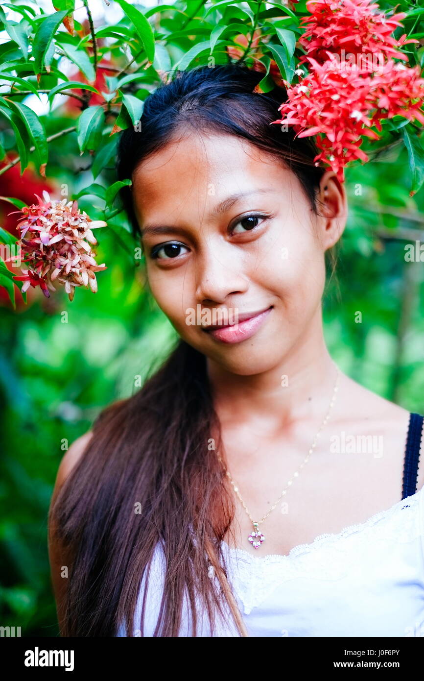 Beautiful assian gilr in the garden with flowers Stock Photo - Alamy