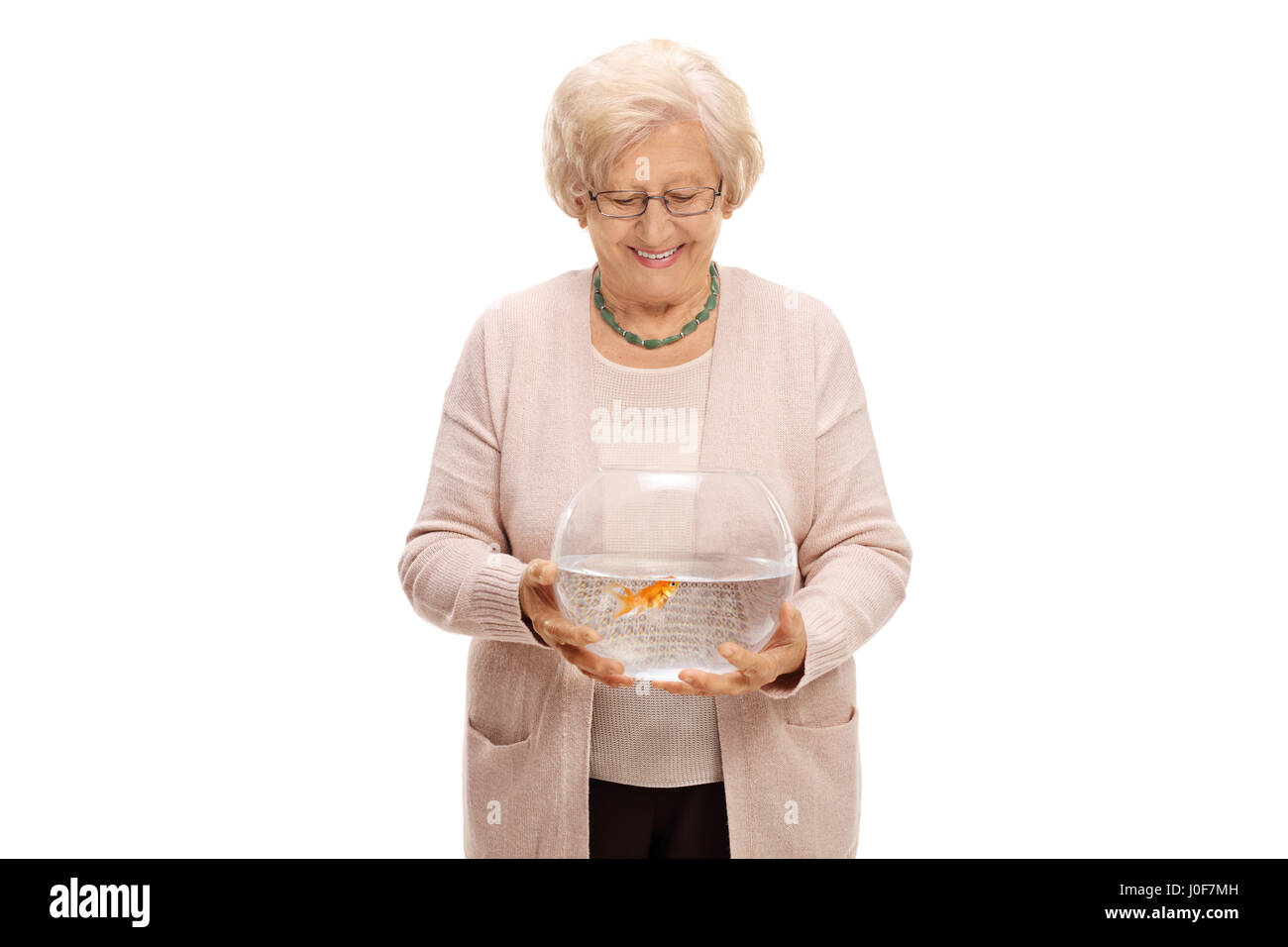 Mature woman holding a bowl with a goldfish isolated on white background Stock Photo