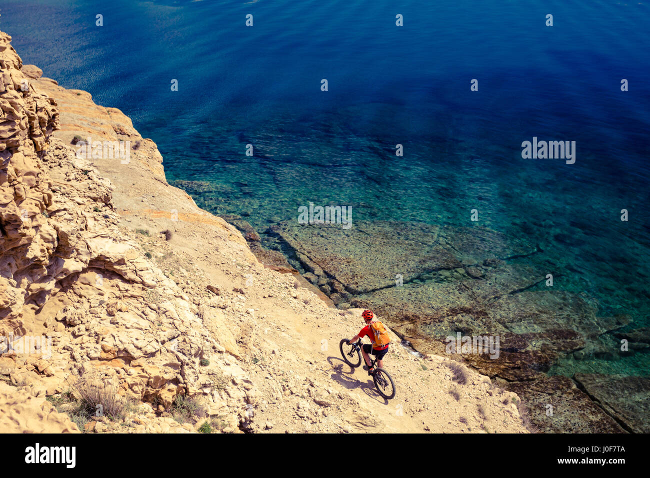 Mountain biker riding on bike in summer inspirational mountains and sea ...