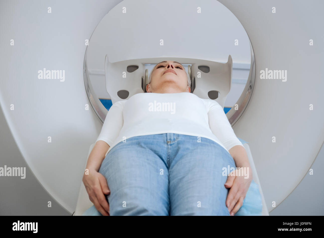 Serious worried patient lying on the examination table Stock Photo