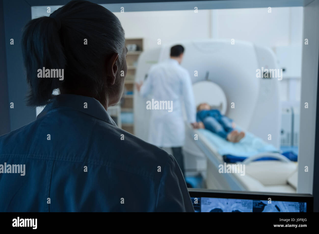 Nice experienced doctor looking at the CT lab Stock Photo