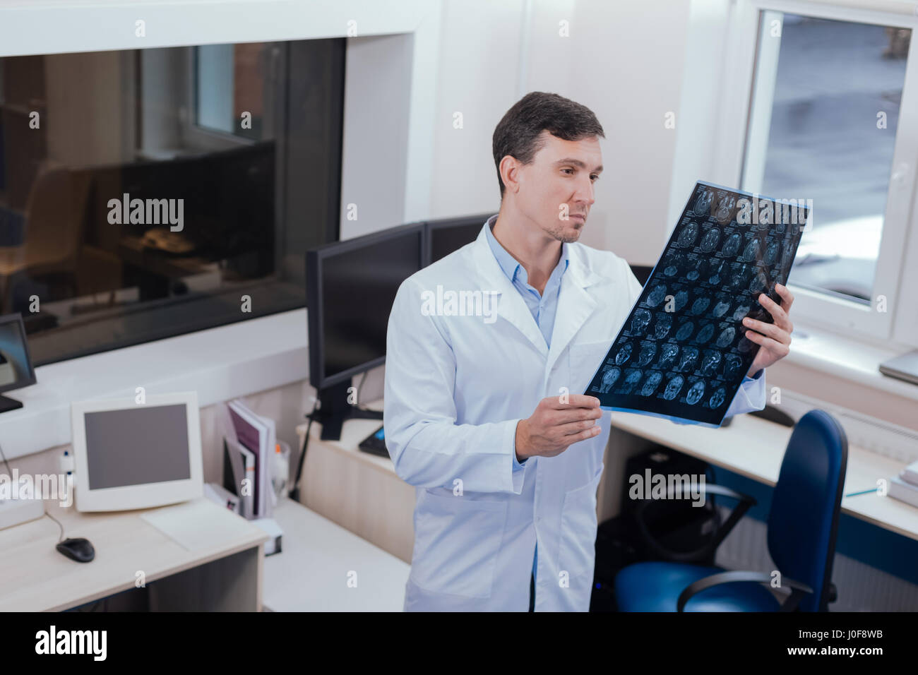 Serious male radiologist thinking about diagnosis Stock Photo - Alamy