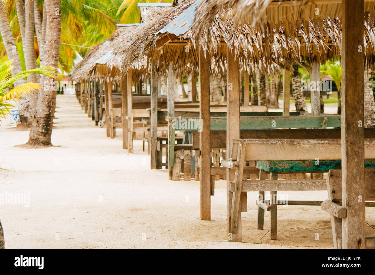 Nipa huts on the white coral sand beach surounded with palms Stock Photo Alamy
