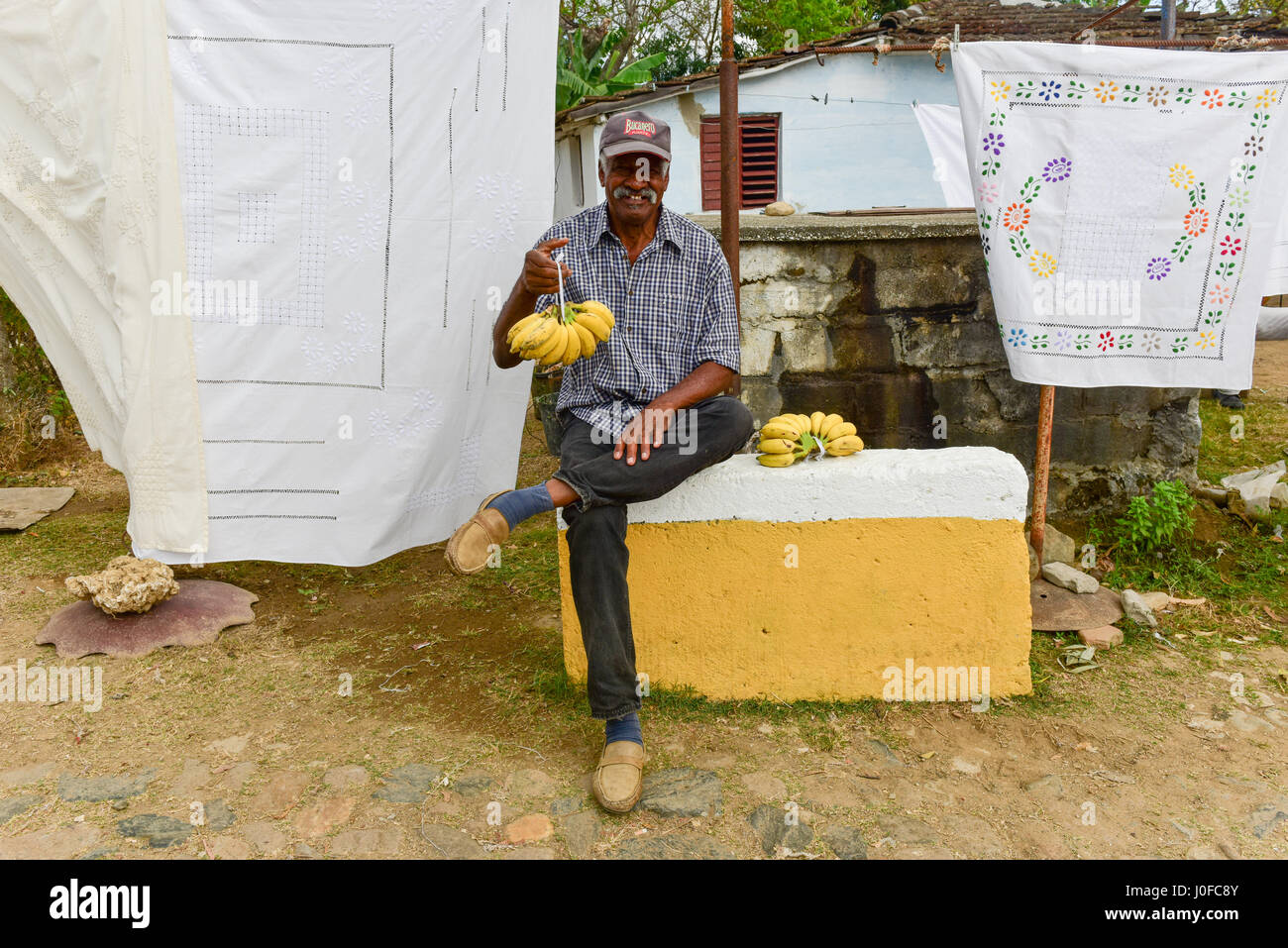 Manaca Iznaga, Cuba - Jan 12, 2017: Cuban man selling bananas in Manaca Iznaga, Valle de los Ingenios, Trinidad, Cuba. Stock Photo