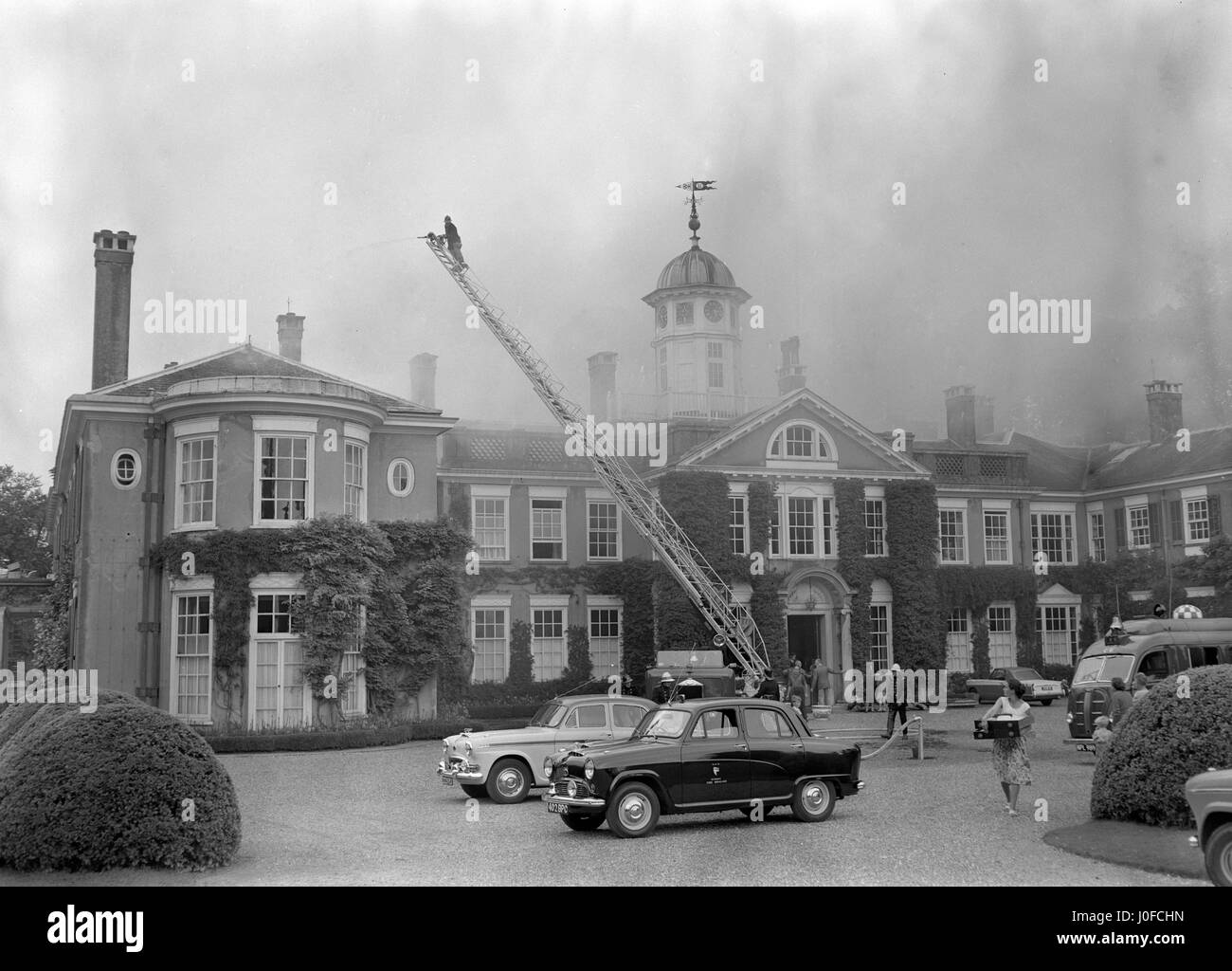 Polesden Lacey, near Dorking, Surrey, when fire broke out in the roof. A total of 22 jets, 10 breathing apparatus sets and a turntable ladder were rushed to the scene from across Surrey. Stock Photo