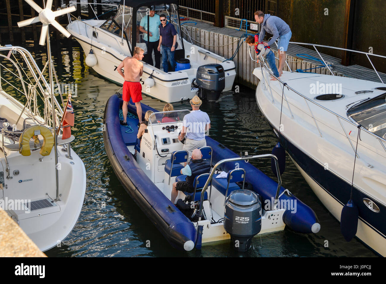 Boats mooring up in a harbour Stock Photo