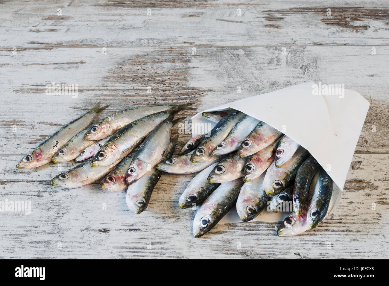 fresh sardines in foil from above Stock Photo Alamy