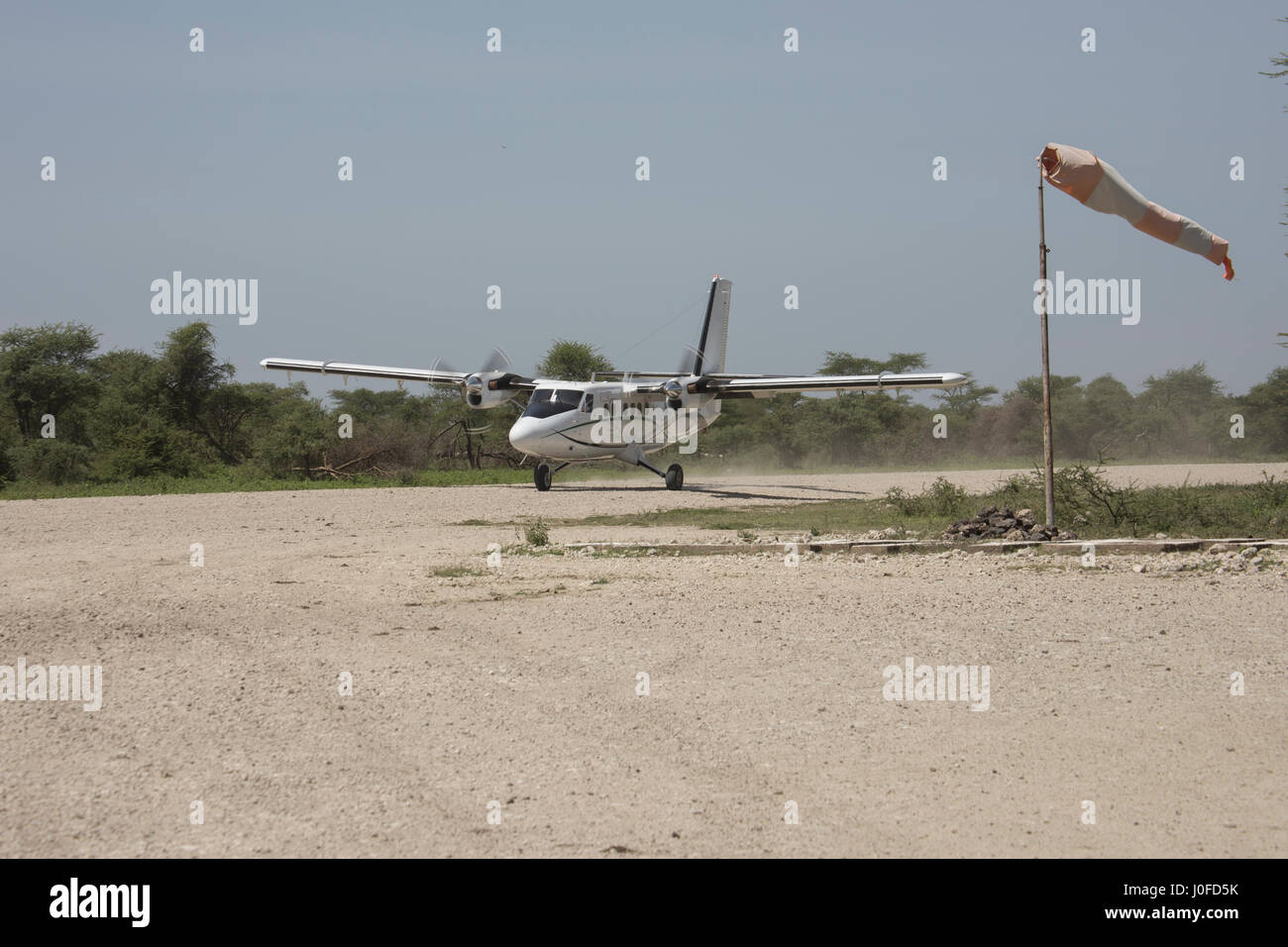 Small prop plane on dirt runway in Serengeti, Tanzania, Africa. Stock Photo