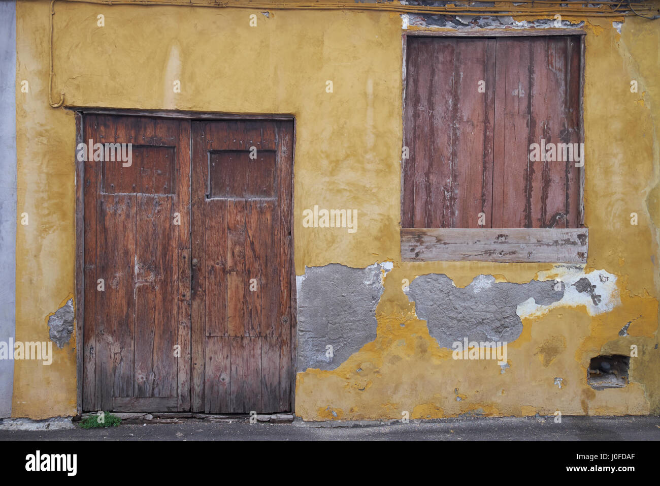 Wooden doorway and shuttered window  of old building in Garachico, Tenerife, Canary Islands, Spain. Stock Photo