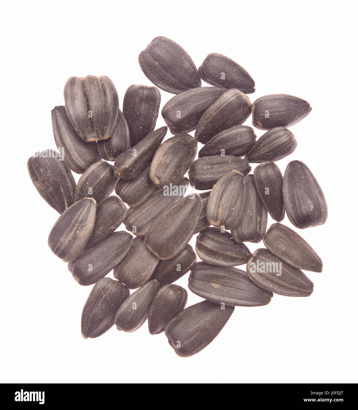 black sunflower seeds isolated on white background Stock Photo - Alamy