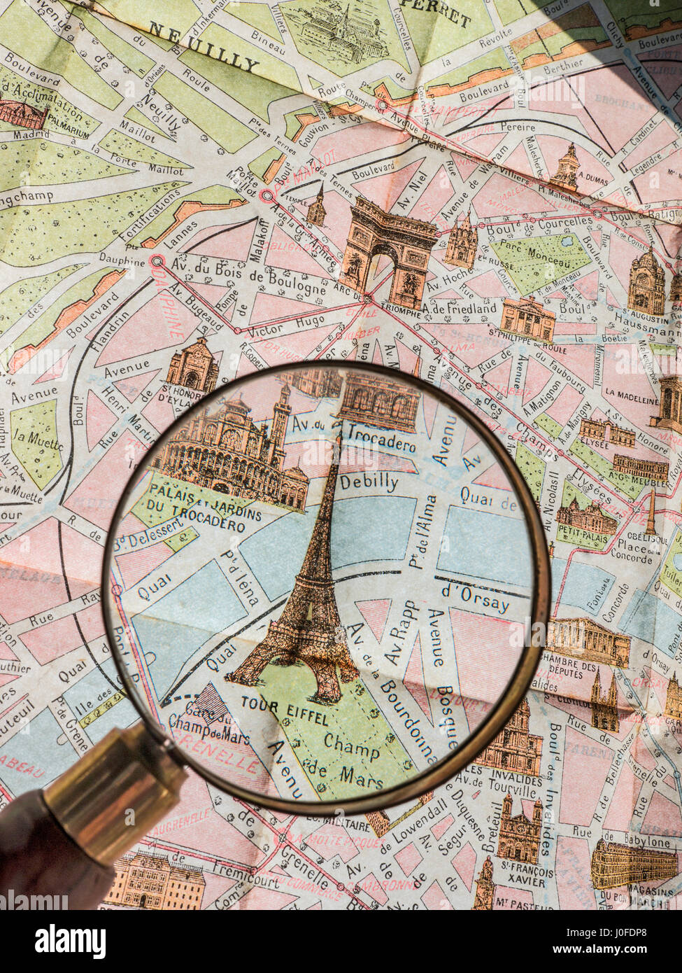 EIFFEL TOWER PARIS OLD Magnifying Glass on detail of rare 1900's vintage retro colour Monumental Map of Paris, featuring Eiffel Tower & Trocadero etc Stock Photo