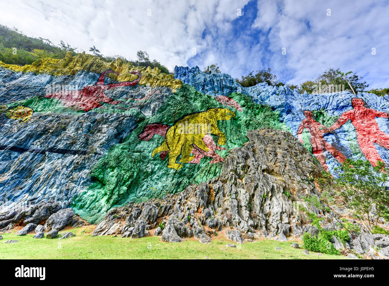 Mural de la Prehistoria, a giant mural painted on a cliff face in the Vinales area of Cuba. It is 120m long and took 18 people 4 years to complete. Stock Photo