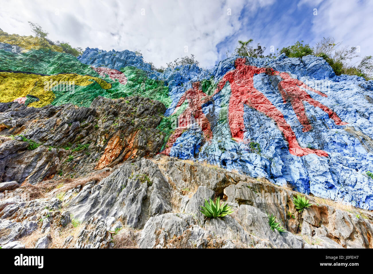 Mural de la Prehistoria, a giant mural painted on a cliff face in the Vinales area of Cuba. It is 120m long and took 18 people 4 years to complete. Stock Photo