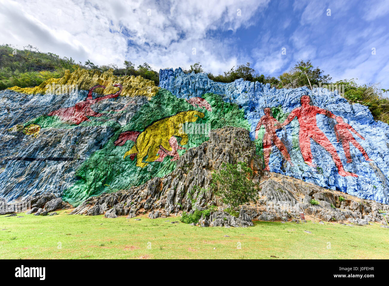 Mural de la Prehistoria, a giant mural painted on a cliff face in the Vinales area of Cuba. It is 120m long and took 18 people 4 years to complete. Stock Photo