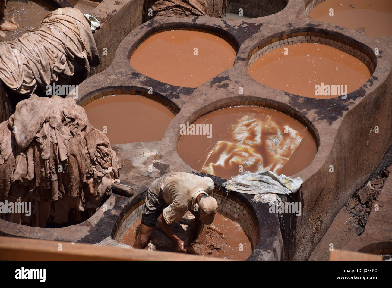 Man working at leather tannery in Fez Morocco Stock Photo