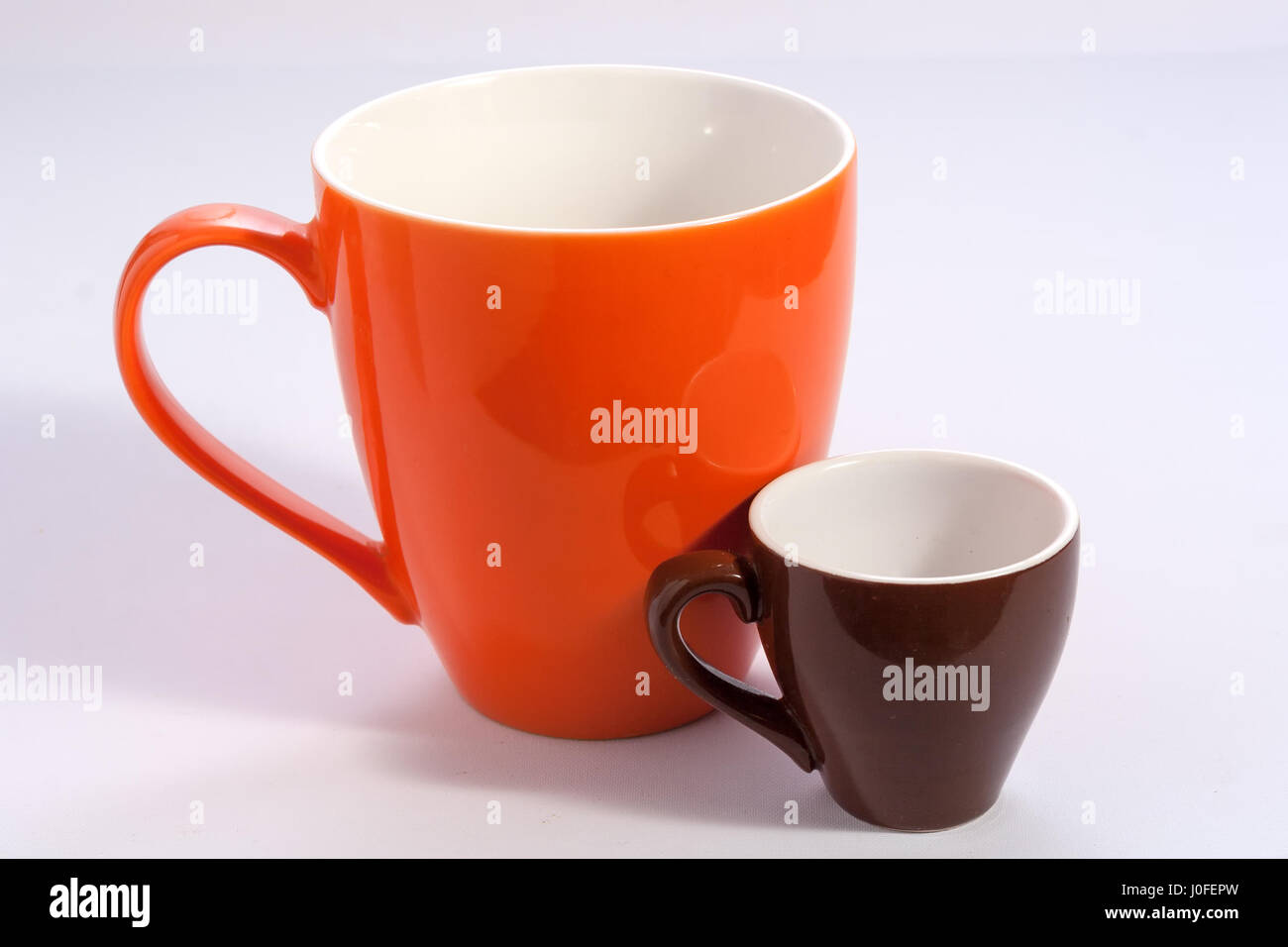 https://c8.alamy.com/comp/J0FEPW/two-cups-one-big-orange-and-one-small-brown-J0FEPW.jpg