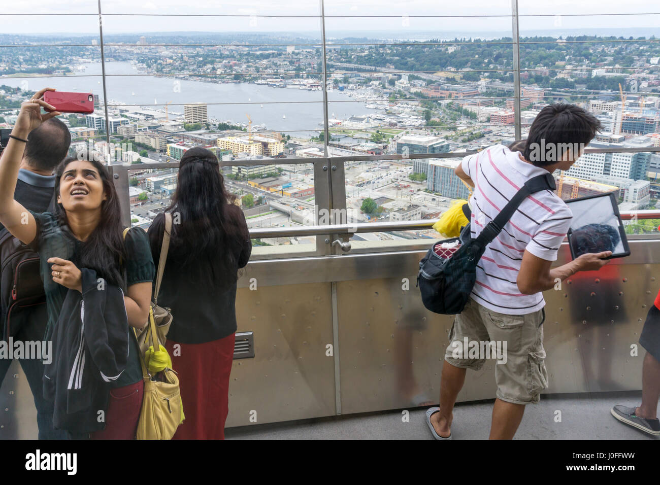 People taking photographs from the observation deck of the Space Needle in Seattle. Stock Photo