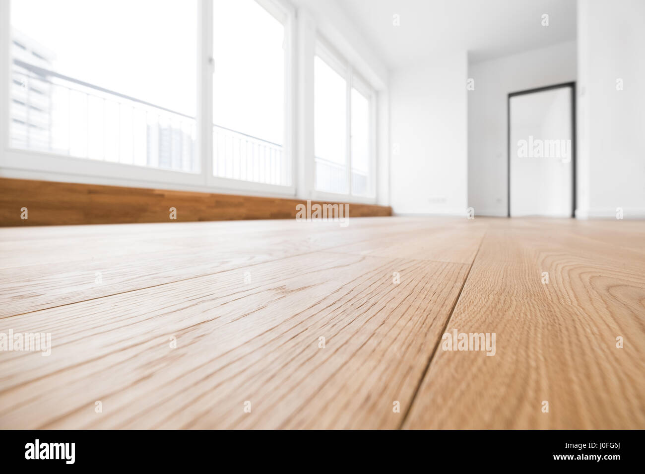 empty room with wooden floor in new apartment Stock Photo