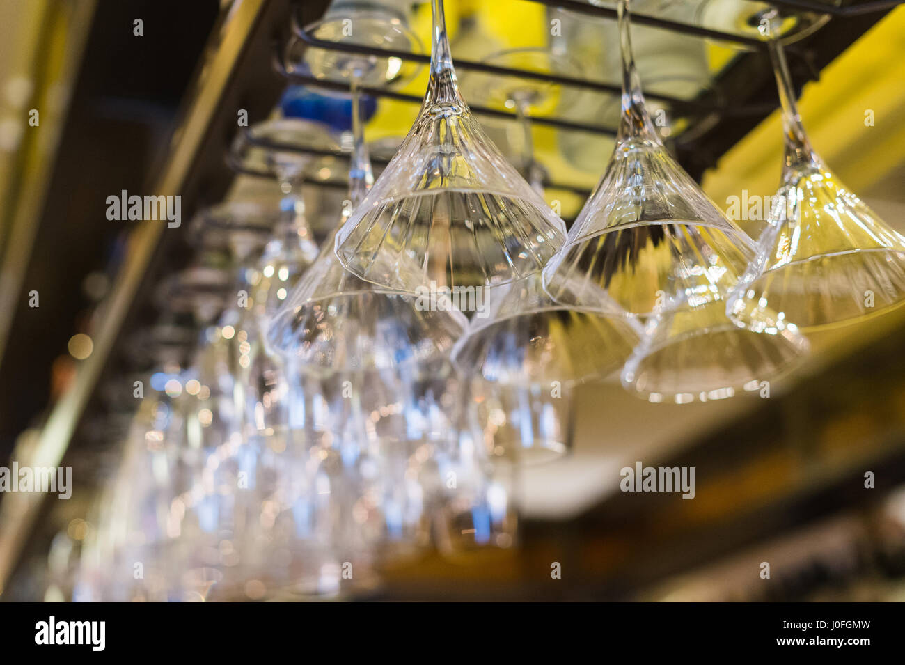 Cocktail Glasses Hanging Upside Down in a Restaurant Bar Stock Photo