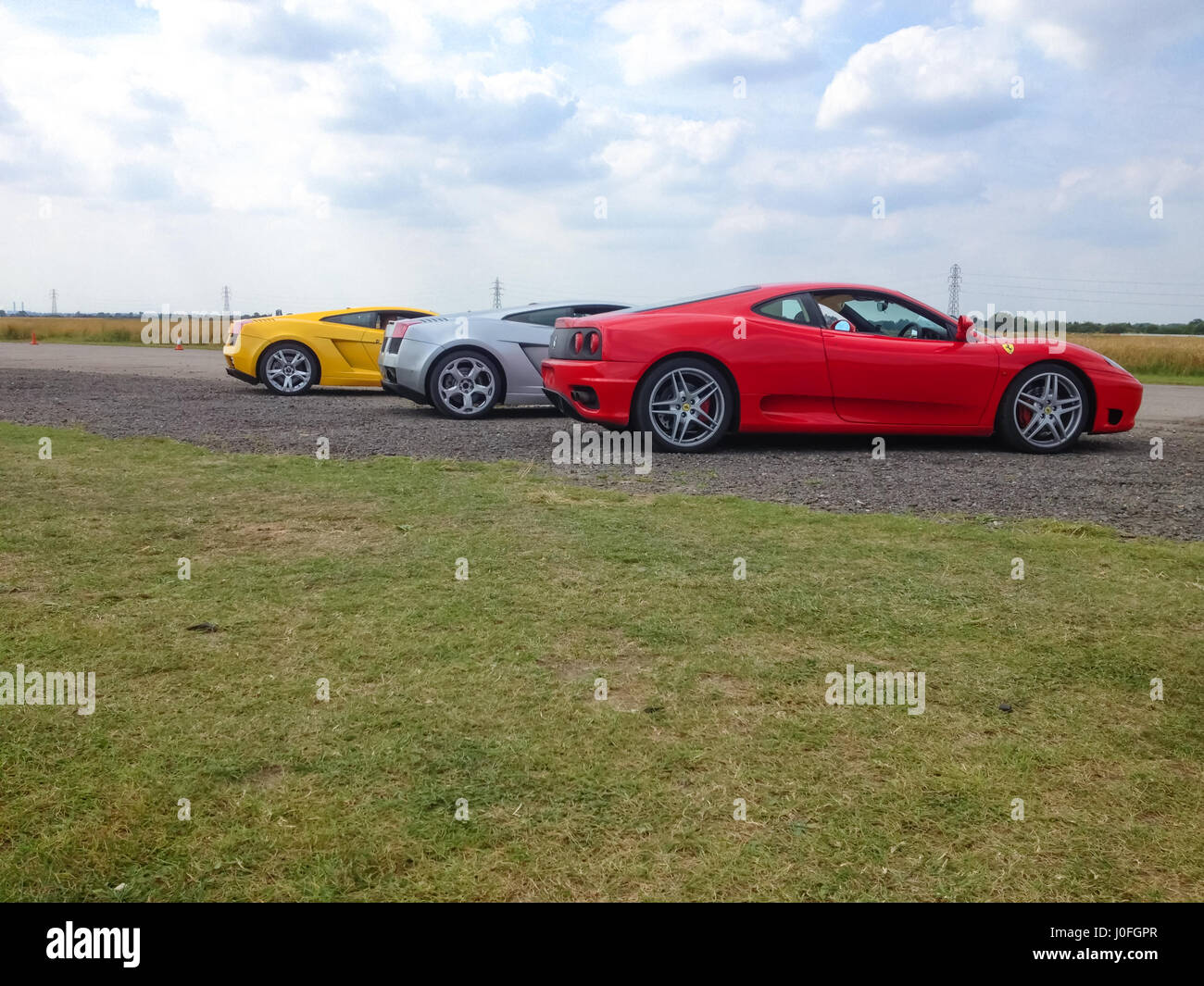 Three Super Sars - Red Ferrari 488, Silver Lamborghini Murcielago, Yellow Lamborghini  Murcielago Stock Photo - Alamy