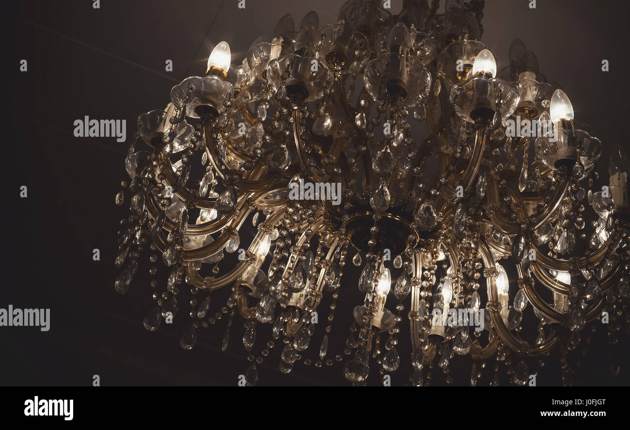 Chandelier details, vintage style with lot of crystal parts and light bulbs. Stock Photo