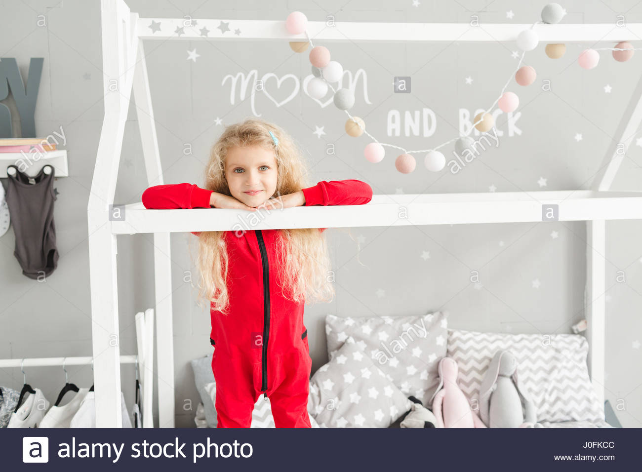 Little Girl With White Curly Hair In Red Pajamas Laughing At Stock