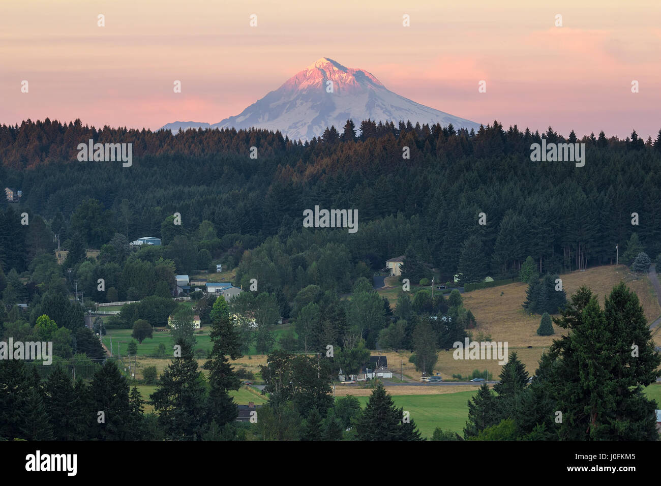 Last evening light on Mount Hood over rural farmland in Clackamas County Oregon Stock Photo