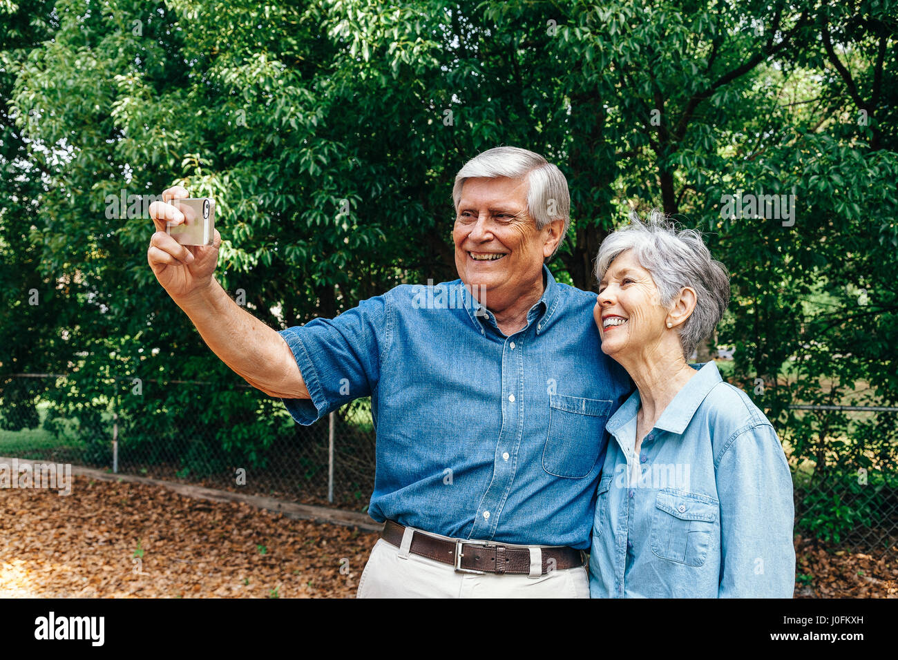 Senior Couple Taking Selfie in Park Stock Photo - Alamy