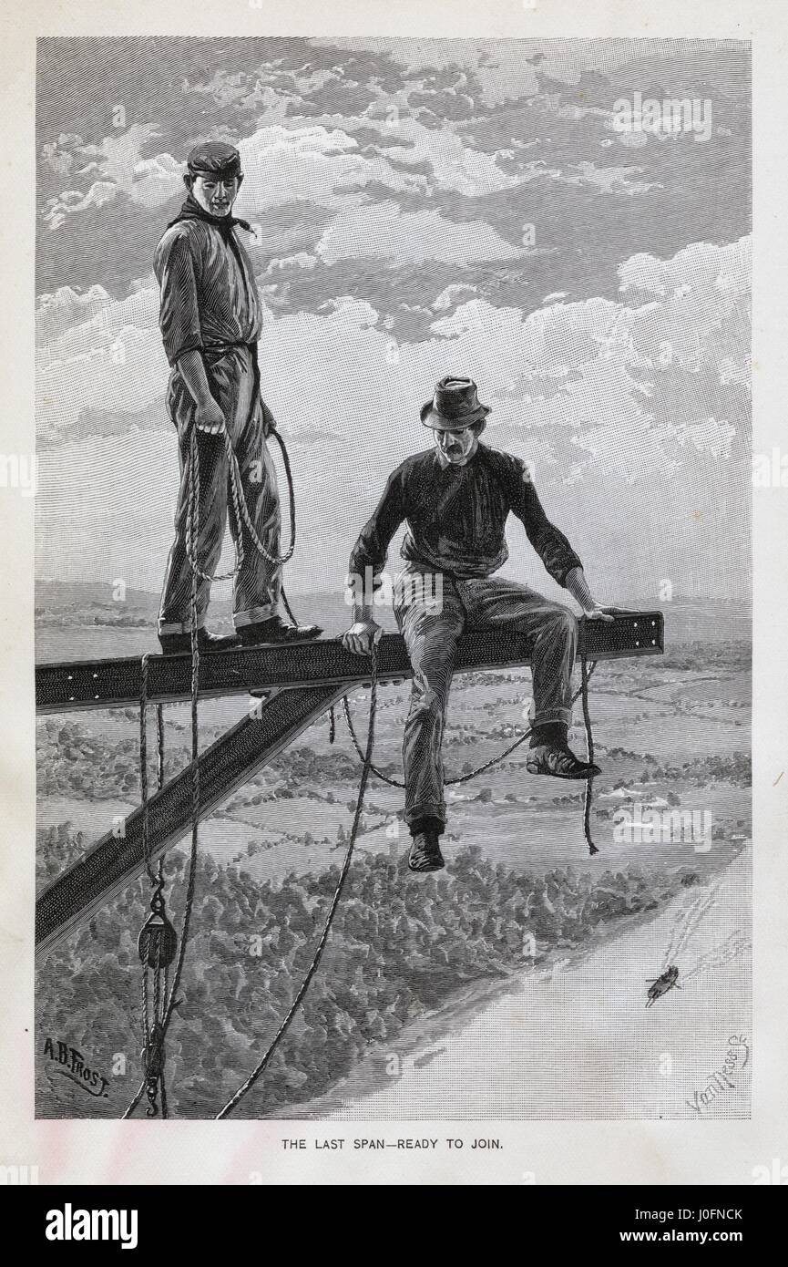 Two men ready to join the last span of a railway bridge Stock Photo