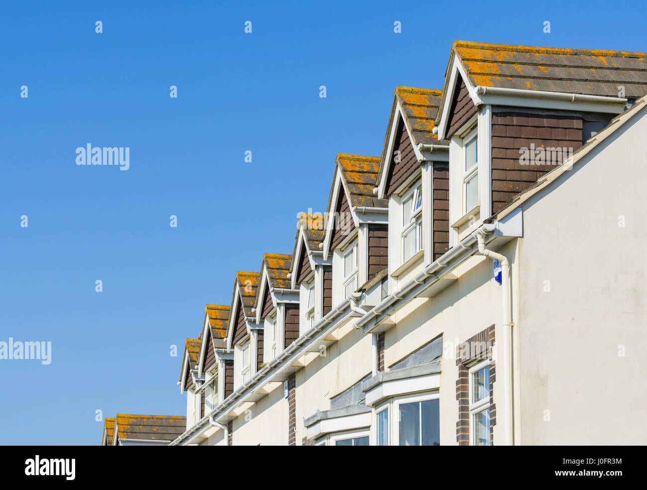 Dormer windows in the roofing of a terraced houses in the UK. Stock Photo