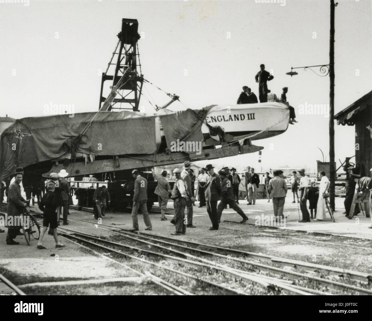 Held aloft by a crane on land, Miss England III, a speedboat built by Thornycroft Stock Photo