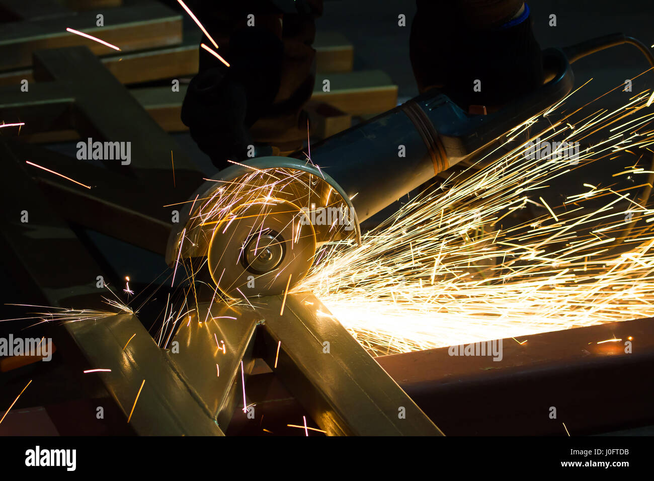 sharpening and cutting of iron by abrasive disk machine Stock Photo - Alamy