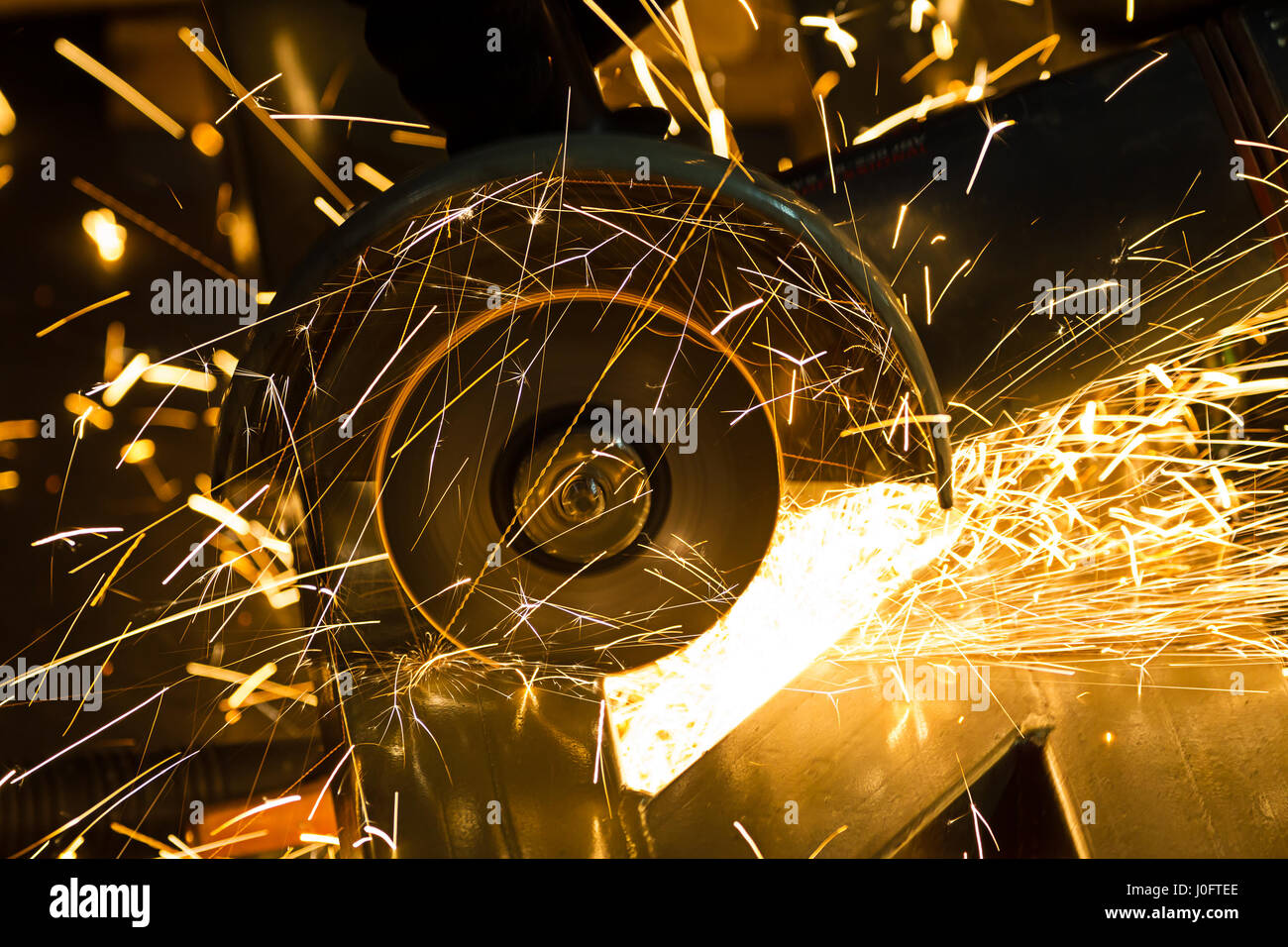 sharpening and cutting of iron by abrasive disk machine Stock Photo - Alamy