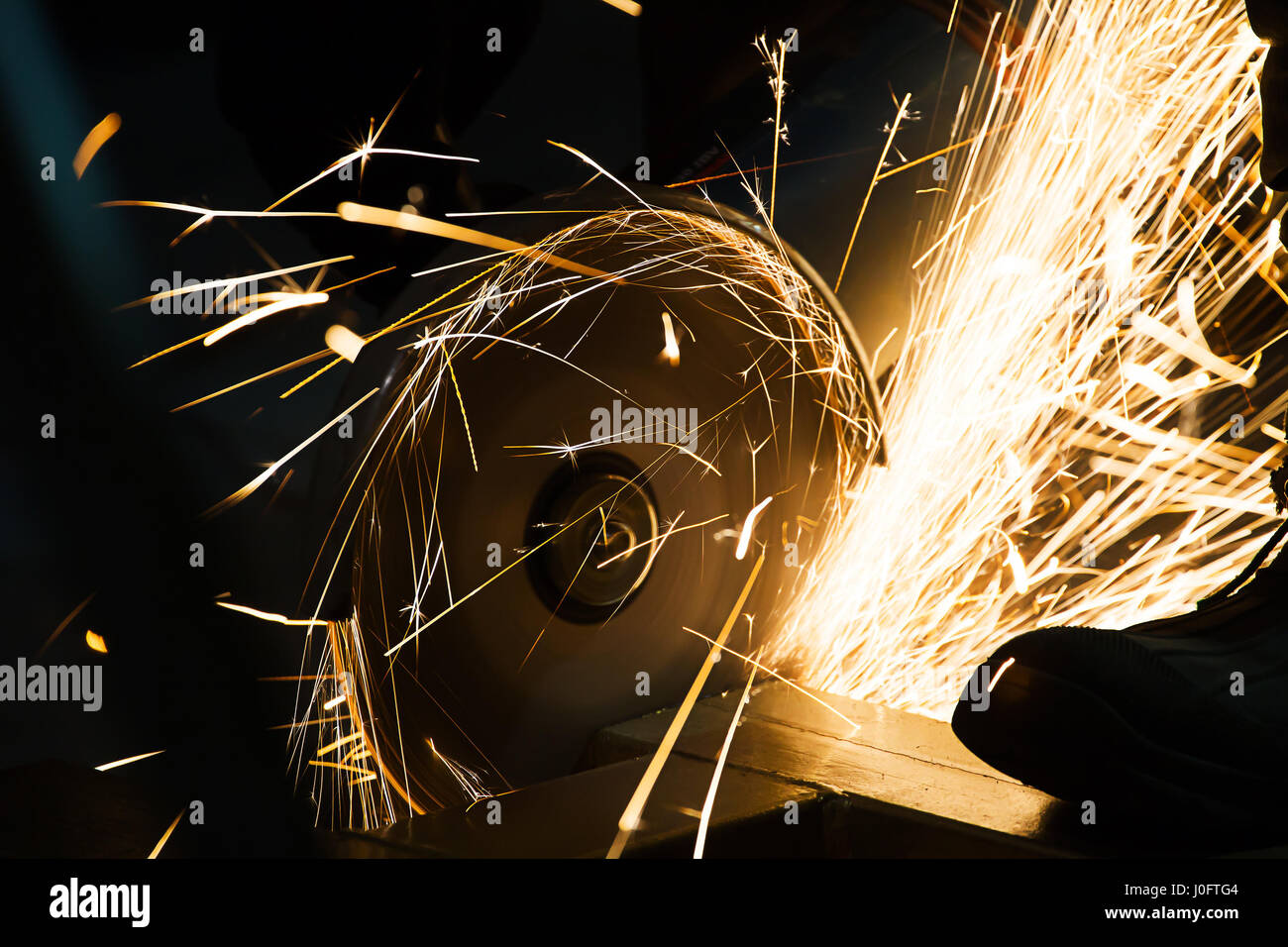 sharpening and cutting of iron by abrasive disk machine Stock Photo - Alamy