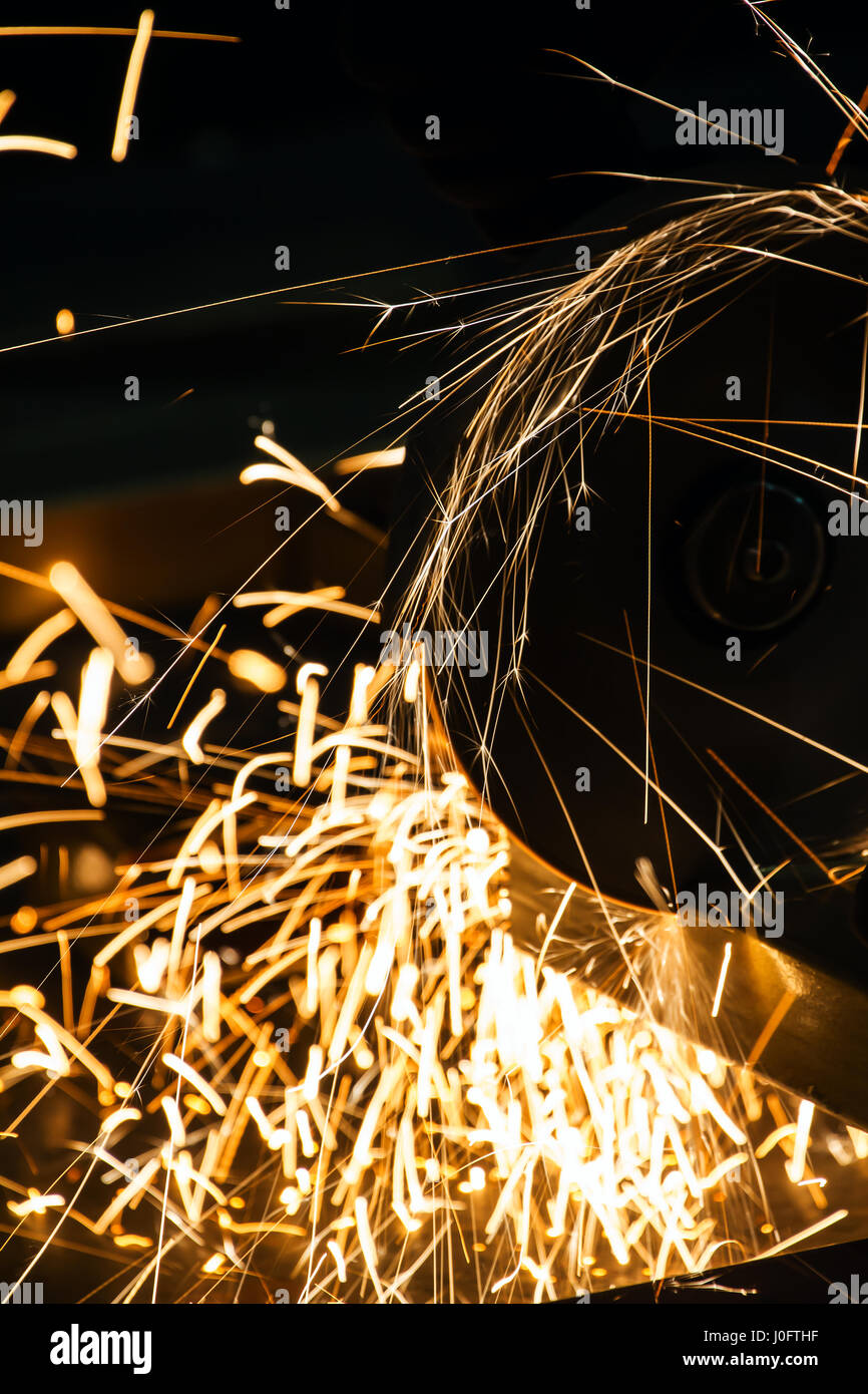 sharpening and cutting of iron by abrasive disk machine Stock Photo - Alamy