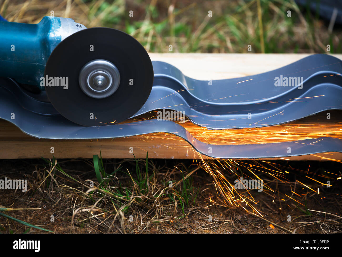 sharpening and cutting of iron by abrasive disk machine Stock Photo - Alamy