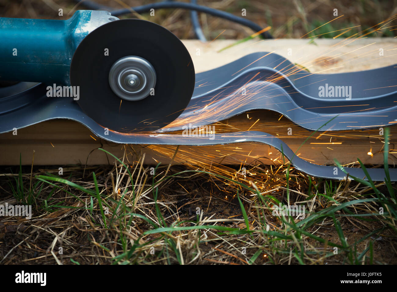 sharpening and cutting of iron by abrasive disk machine Stock Photo - Alamy