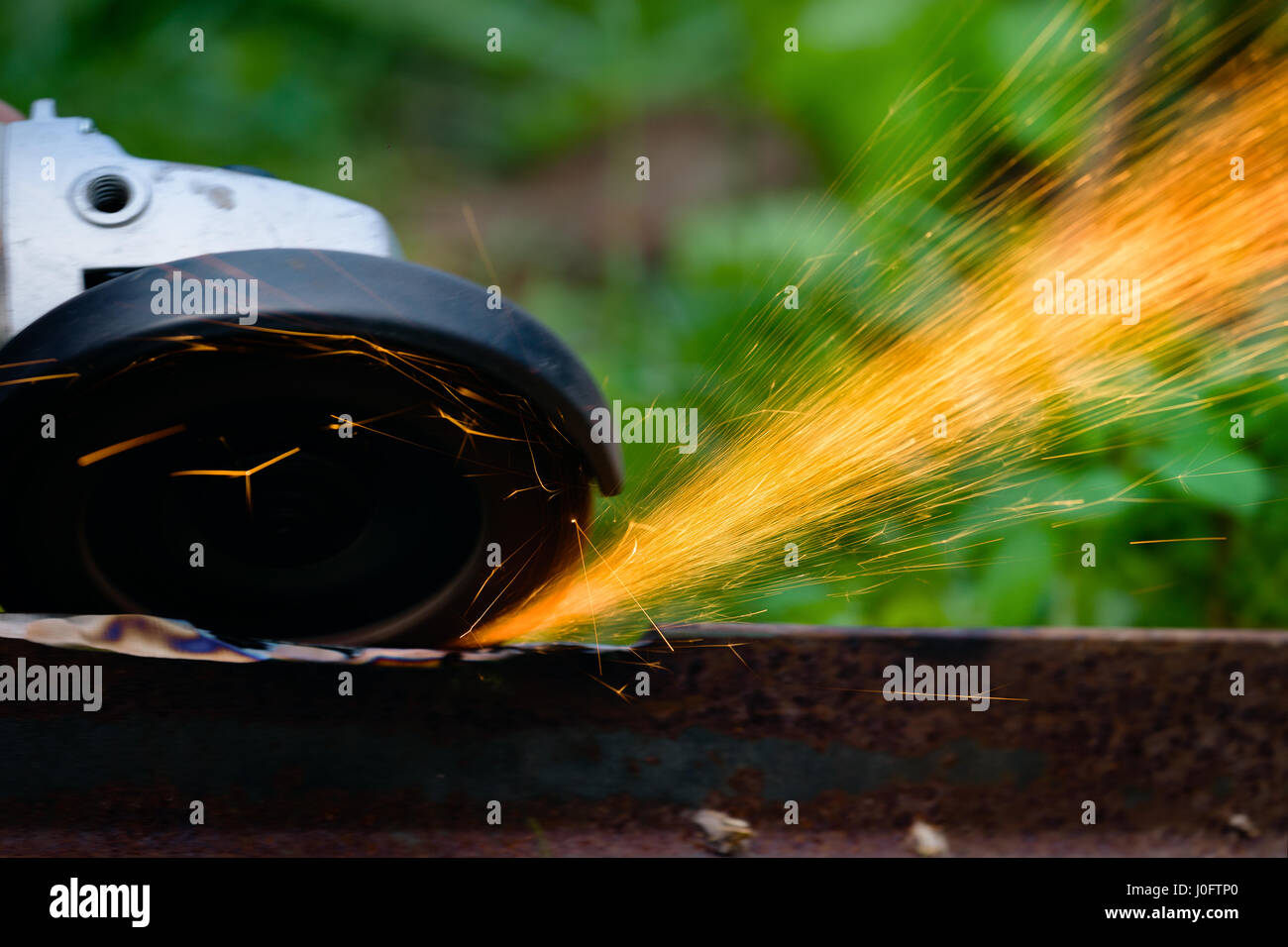 sharpening and cutting of iron by abrasive disk machine Stock Photo - Alamy