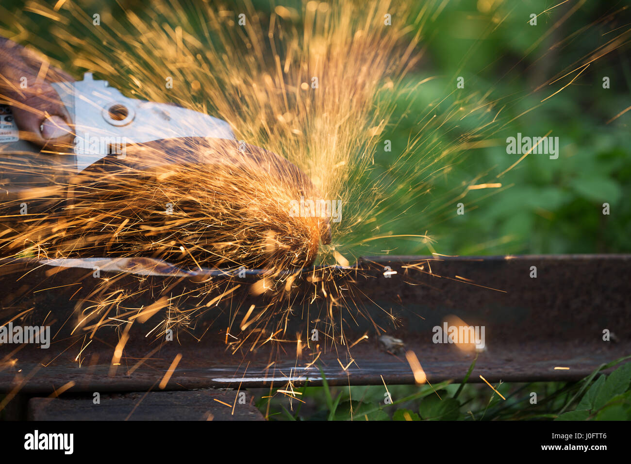 sharpening and cutting of iron by abrasive disk machine Stock Photo - Alamy