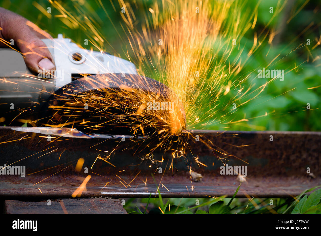 sharpening and cutting of iron by abrasive disk machine Stock Photo - Alamy