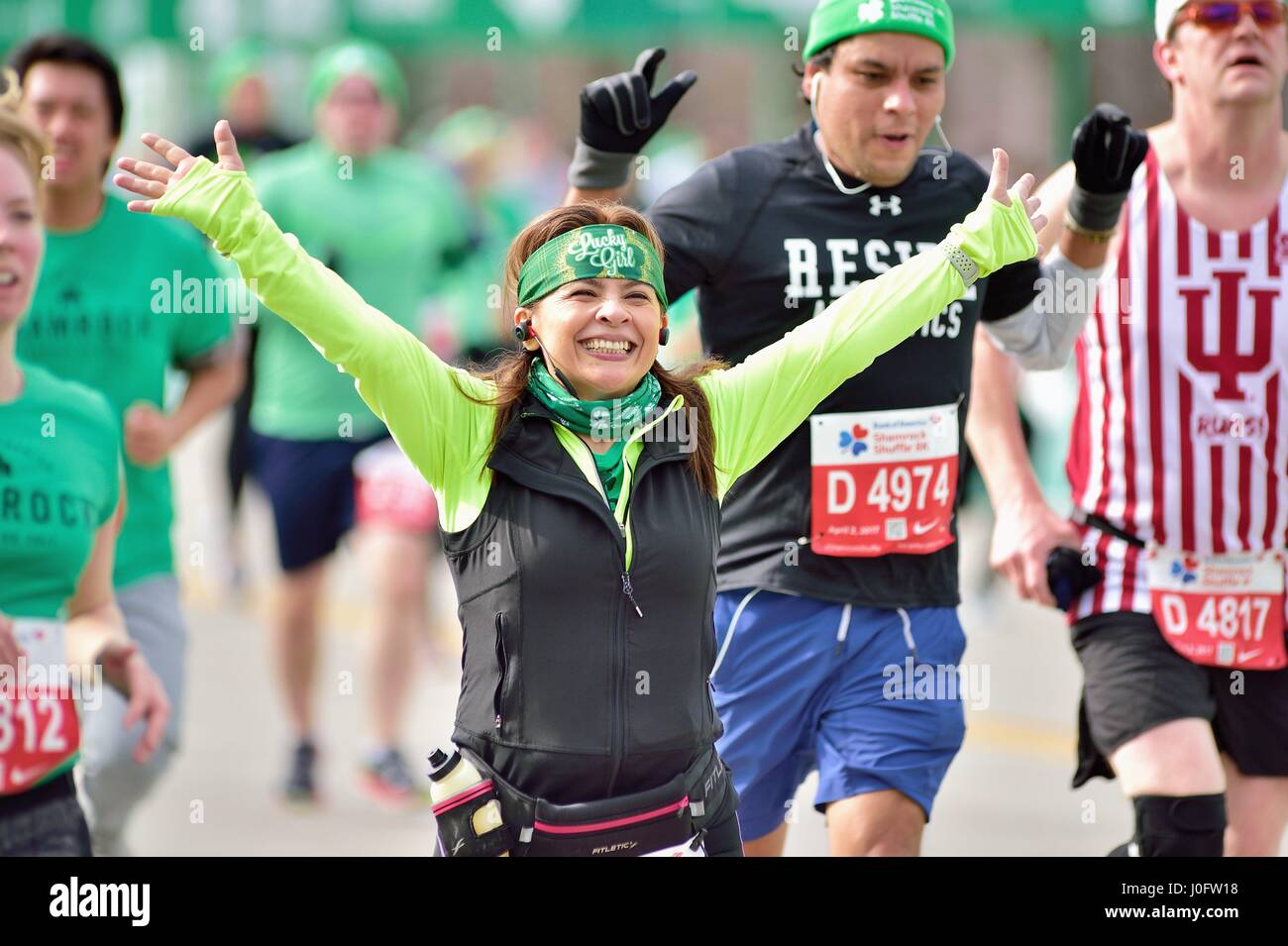 Very happy runner crossing the finish line at the 2017 Shamrock Shuffle race in Chicago, Illinois, USA. Stock Photo