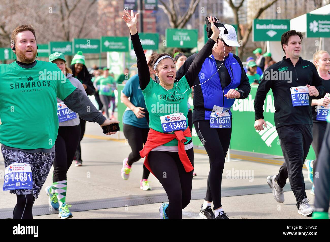 Happy runner crossing the finish line at the 2017 Shamrock Shuffle race in Chicago, Illinois, USA. Stock Photo