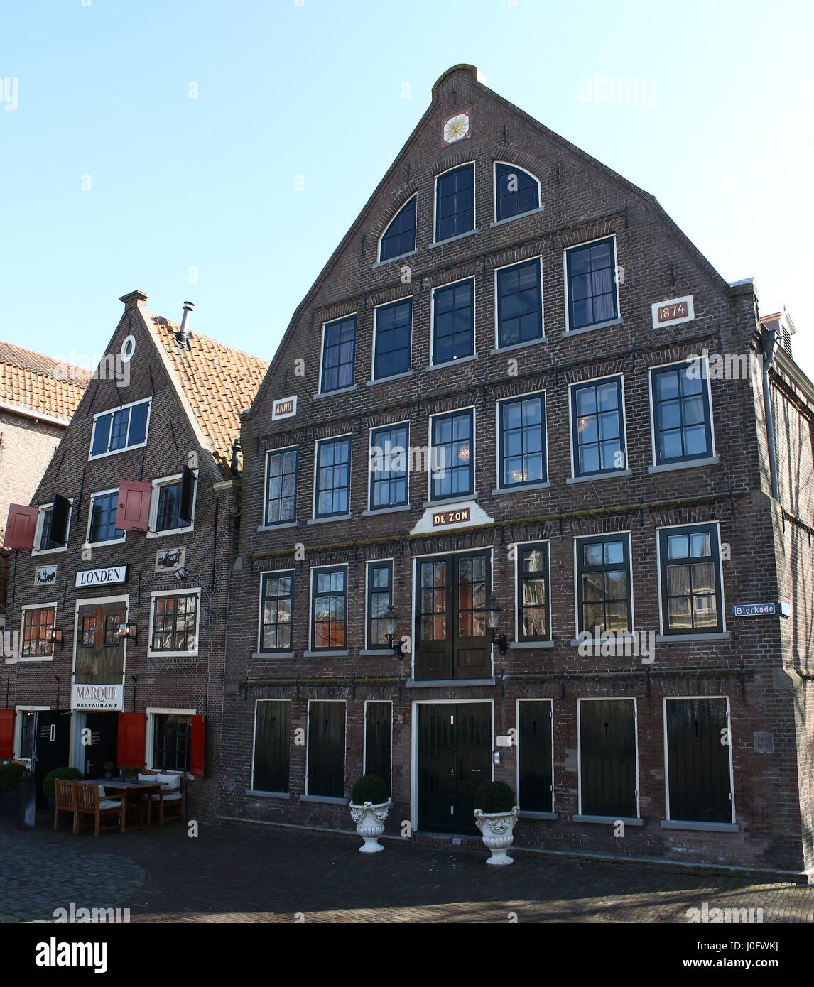 Old warehouses De Zon and Londen along medieval Appelhaven and Bierkade canal, centre of Hoorn, North Holland, Netherlands. (Stitch of 2 images.) Stock Photo