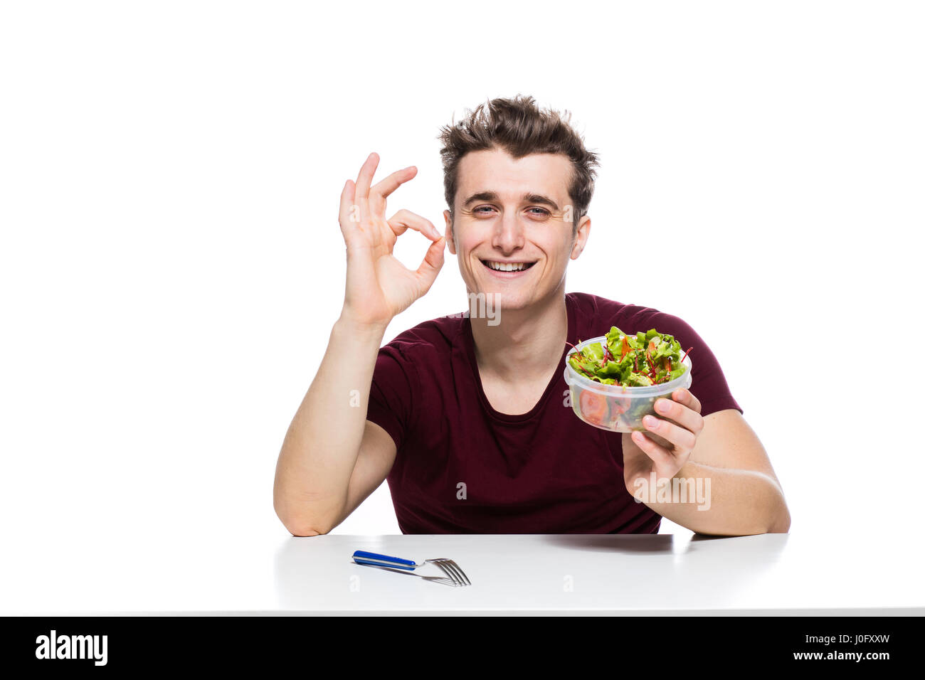 Young man is a happy salad tosser Stock Photo by ©lofilolo 30031259