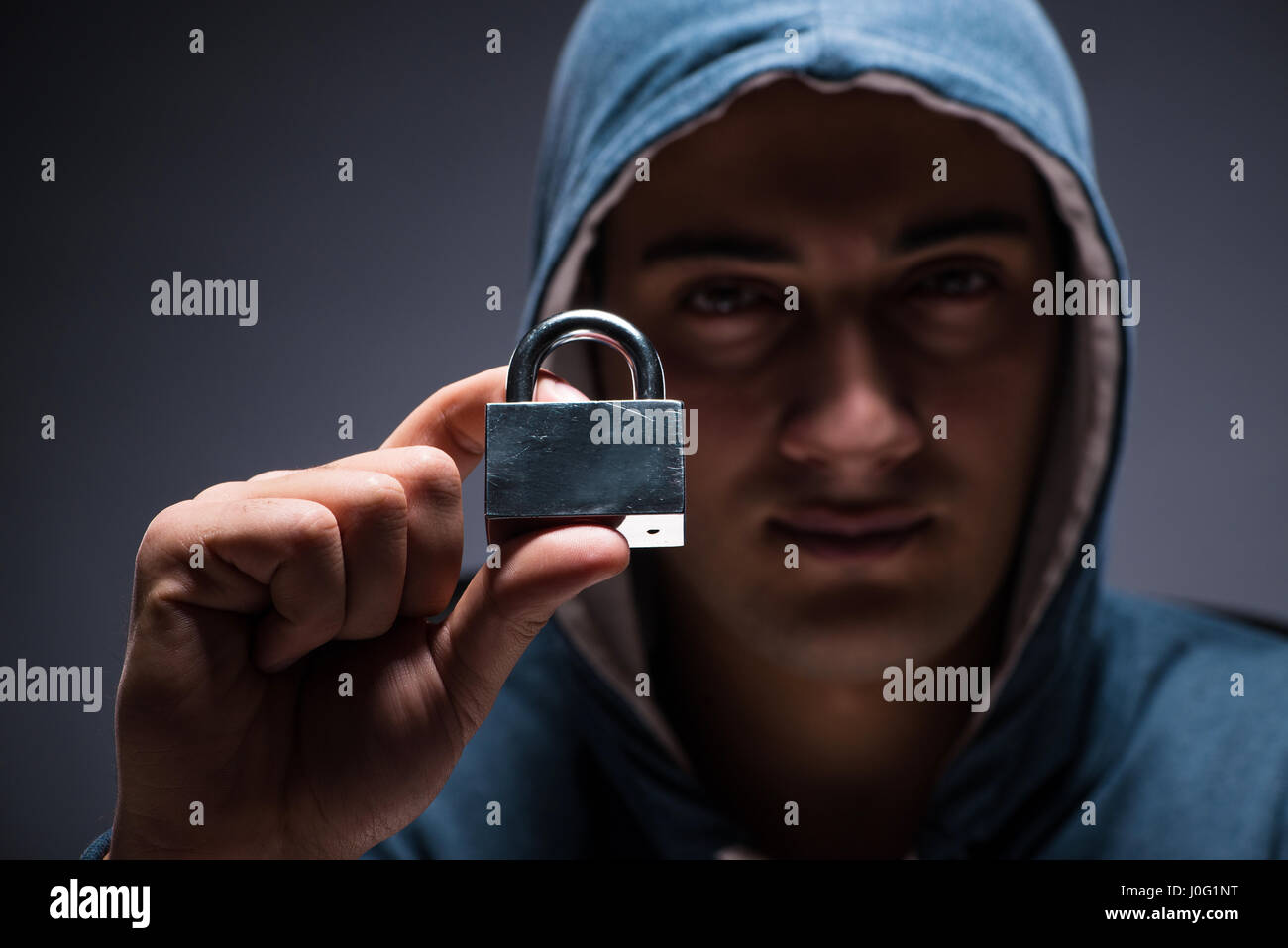 Computer hacker working in dark room Stock Photo - Alamy