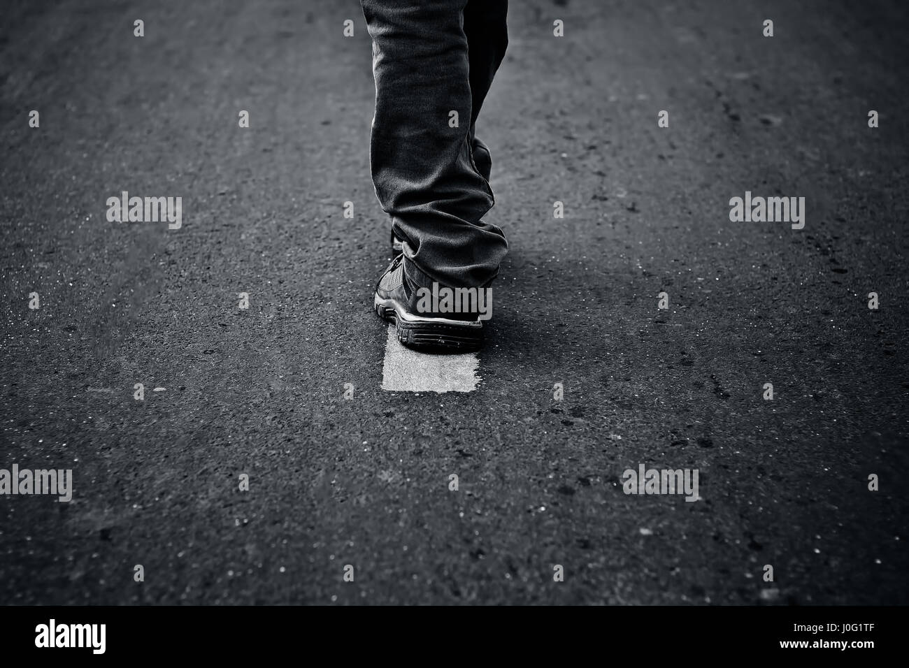 The road less travel. Human figure walking on the road and get two ...